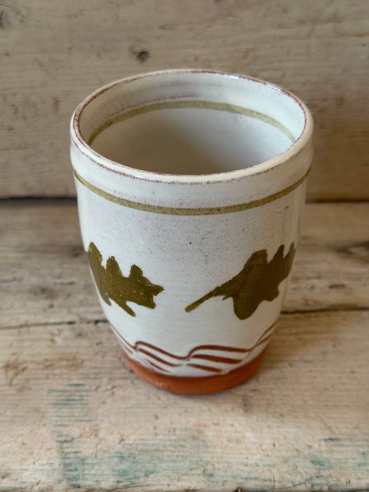 Oak Leaf slipware handleless cup standing square to camera, cream slip with olive oak leaves over a combed terracotta band